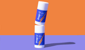 Two Prep U deodorant sticks stacked creatively against a vibrant orange and purple backdrop.