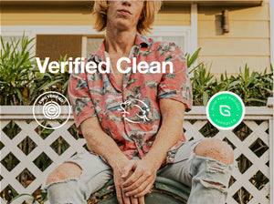 Young man in a vibrant shirt sitting by a fence, showcasing 'Verified Clean' certification logos.