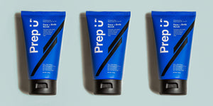 Three tubes of Prep U face and body scrub on a light blue background, featuring a bold blue design.
