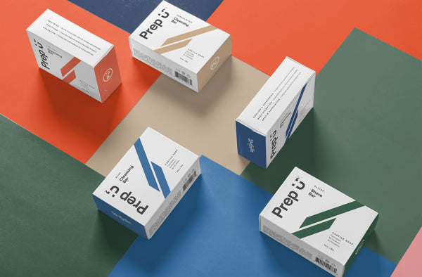 Colorful packaging boxes of Prep U arranged artistically on a vibrant geometric background.