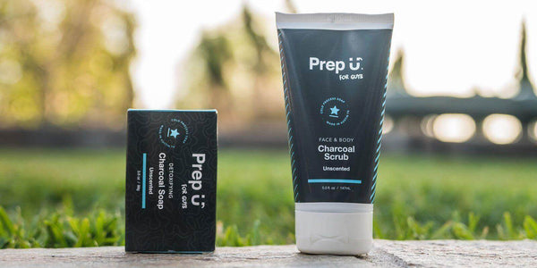 Prep U activated charcoal soap and scrub displayed outdoors in a natural setting, perfect for skincare lovers.
