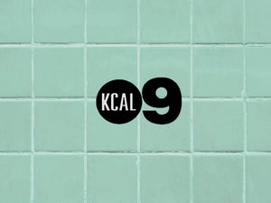 Stylish KCal 9 logo on mint green tiled background, perfect for lifestyle and wellness themes.