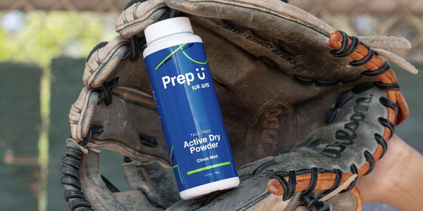 PrepU Active Dry Powder bottle sitting inside a baseball glove, perfect for tackling sweat.