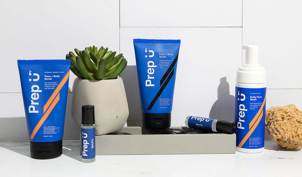 Skincare products arranged with a modern touch, featuring Prep U face and body care items in bold blue packaging.