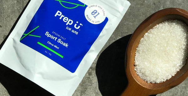 Prep U Sport Soak Epsom salt package surrounded by coarse salt in a wooden bowl, perfect for recovery.