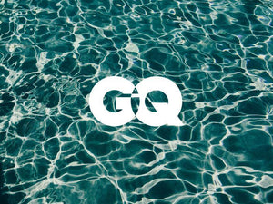 Stylish GQ logo over vibrant water surface, representing modern lifestyle and luxury.