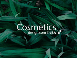 Lush green leaves background featuring Cosmetics design logo and USA text, representing natural beauty.