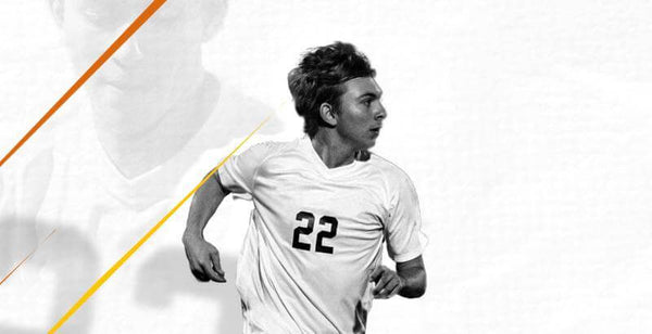 Soccer player sprinting in a white jersey with number 22, showcasing athleticism on the field.