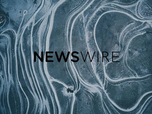 Abstract background design with the word 'NEWSWIRE' prominently featured in a modern font.