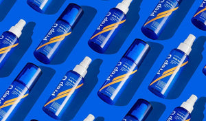 A vibrant display of Prep U guys' hygiene products on a bright blue background, showcasing bottles with modern designs.