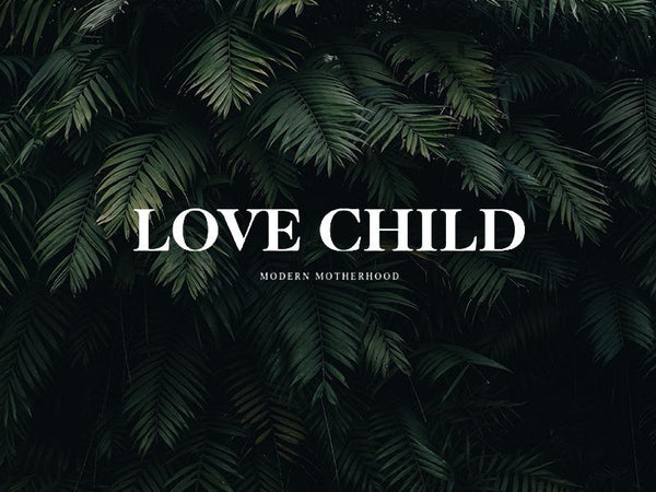 Stylish 'Love Child' logo on lush green leaves representing modern motherhood.