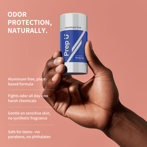 Hand holding a Prep U deodorant stick with product details on a pink background