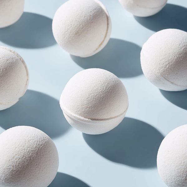 Array of white muscle bath bombs ready to soothe and recharge sore muscles in a relaxing bath.