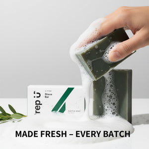 Hand holding a soapy bar next to a box labeled 'Prep U', on a light background.