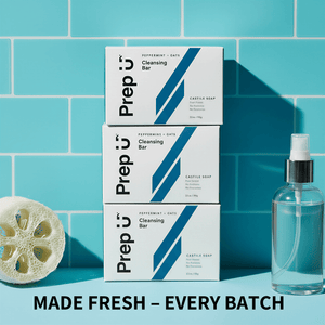 Prep U cleansing bar boxes and a bottle on a blue tiled background