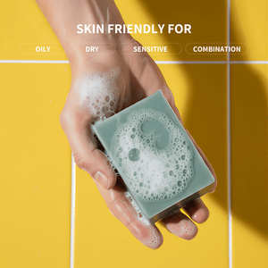 Hand holding a Prep U bar of soap with text indicating skin type compatibility on a yellow background