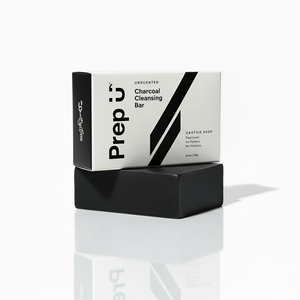 Black charcoal cleansing bar with 'Prep' packaging on a white background