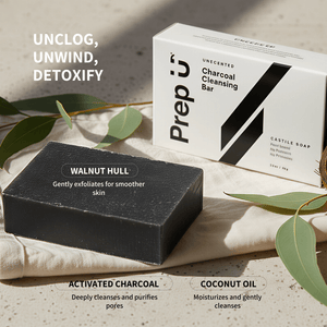 Black soap bar and packaging with text on a neutral background