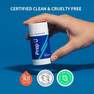 Hand holding a blue and white Prep U deodorant stick with certification logos on a blue background