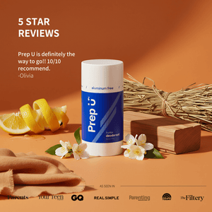 Prep U deodorant with lemon, flowers, and wooden block on an orange background