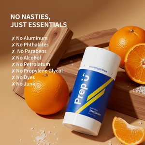 Prep U deodorant stick with oranges on a wooden surface, highlighting ingredient-free benefits.