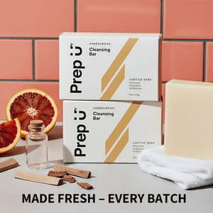 Prep U cleansing bars with packaging, soap, and towel on a tiled background