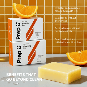Two boxes of Prep U Tea Tree Cleansing Bar with a bar of soap in front, set against an orange tiled wall.